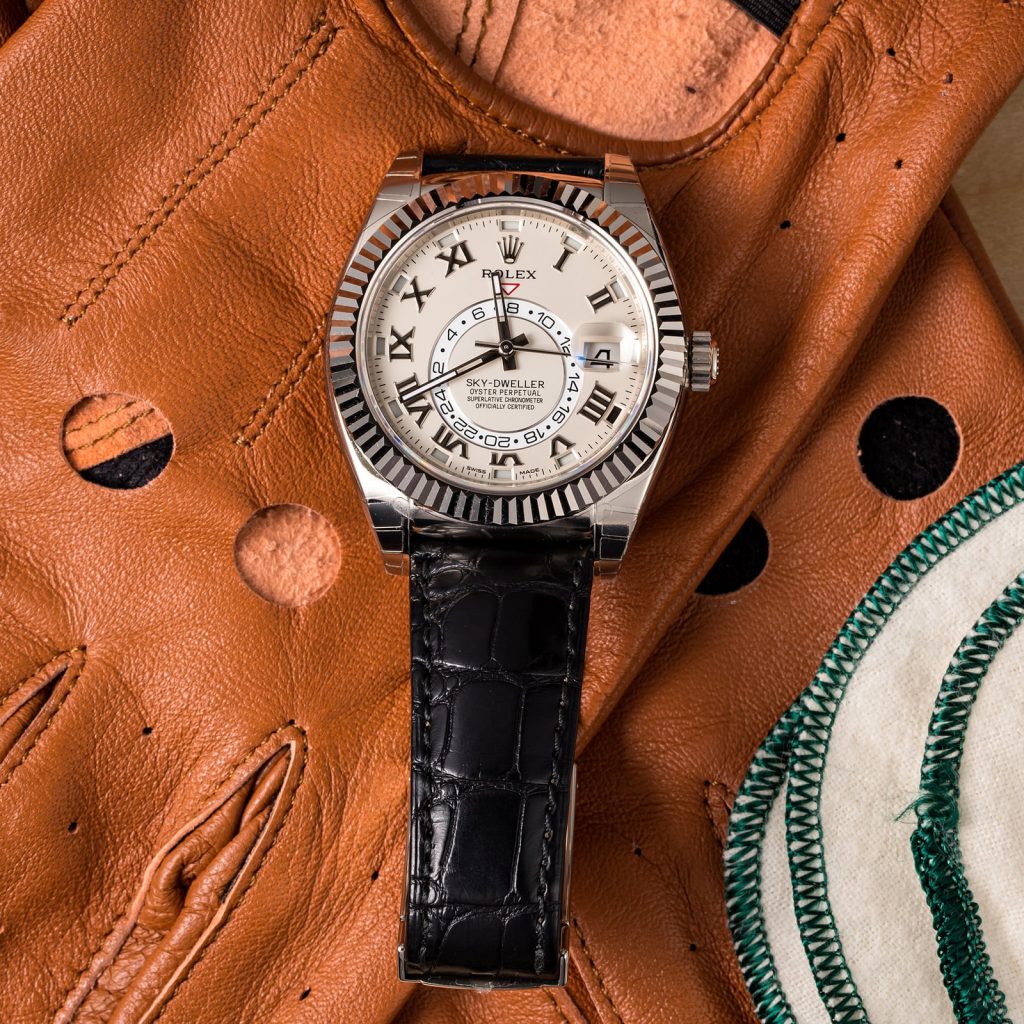 The black strap fake watch has Roman numerals.
